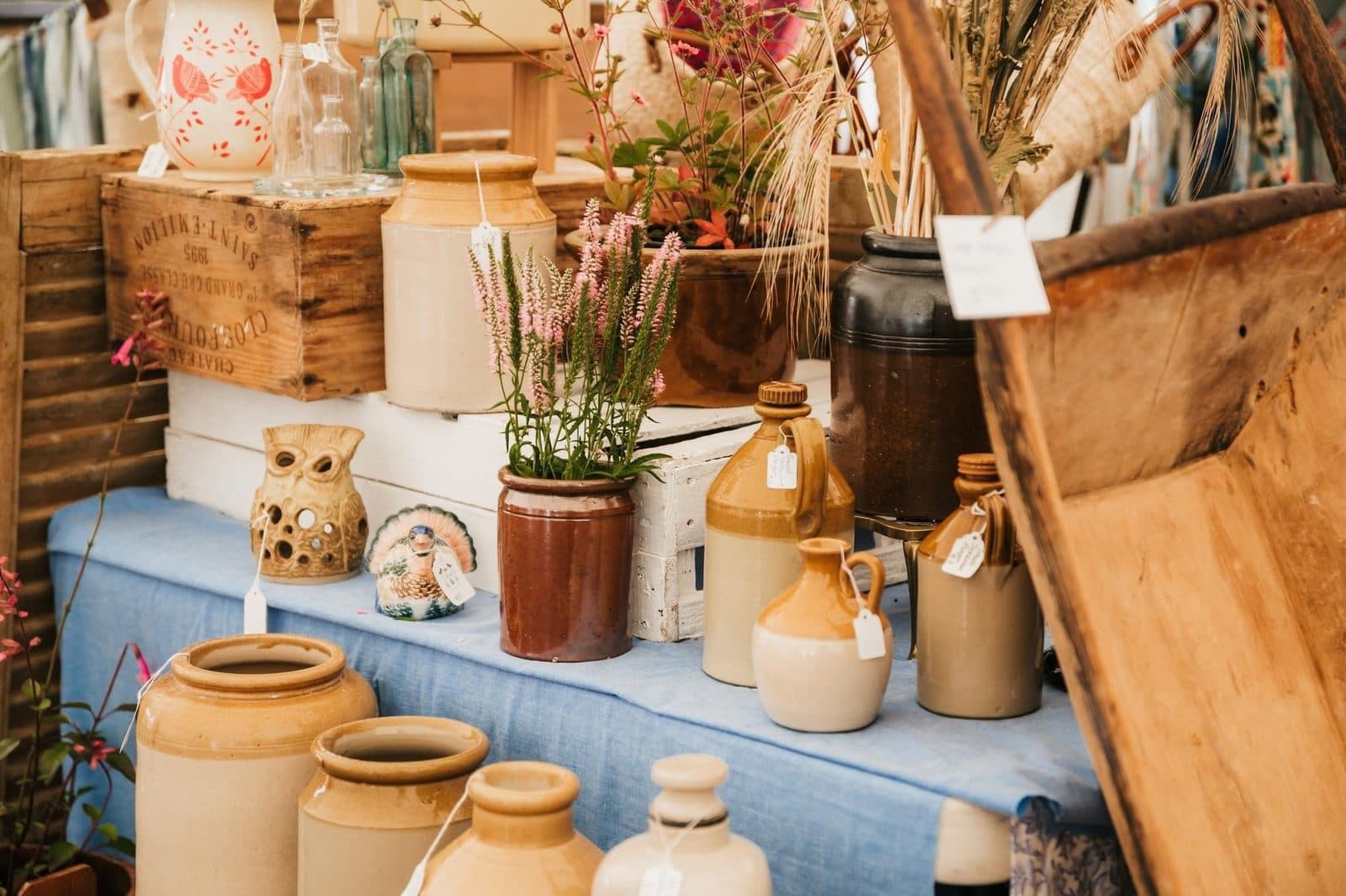 A stall of vintage stoneware crocks, jugs and country homewares