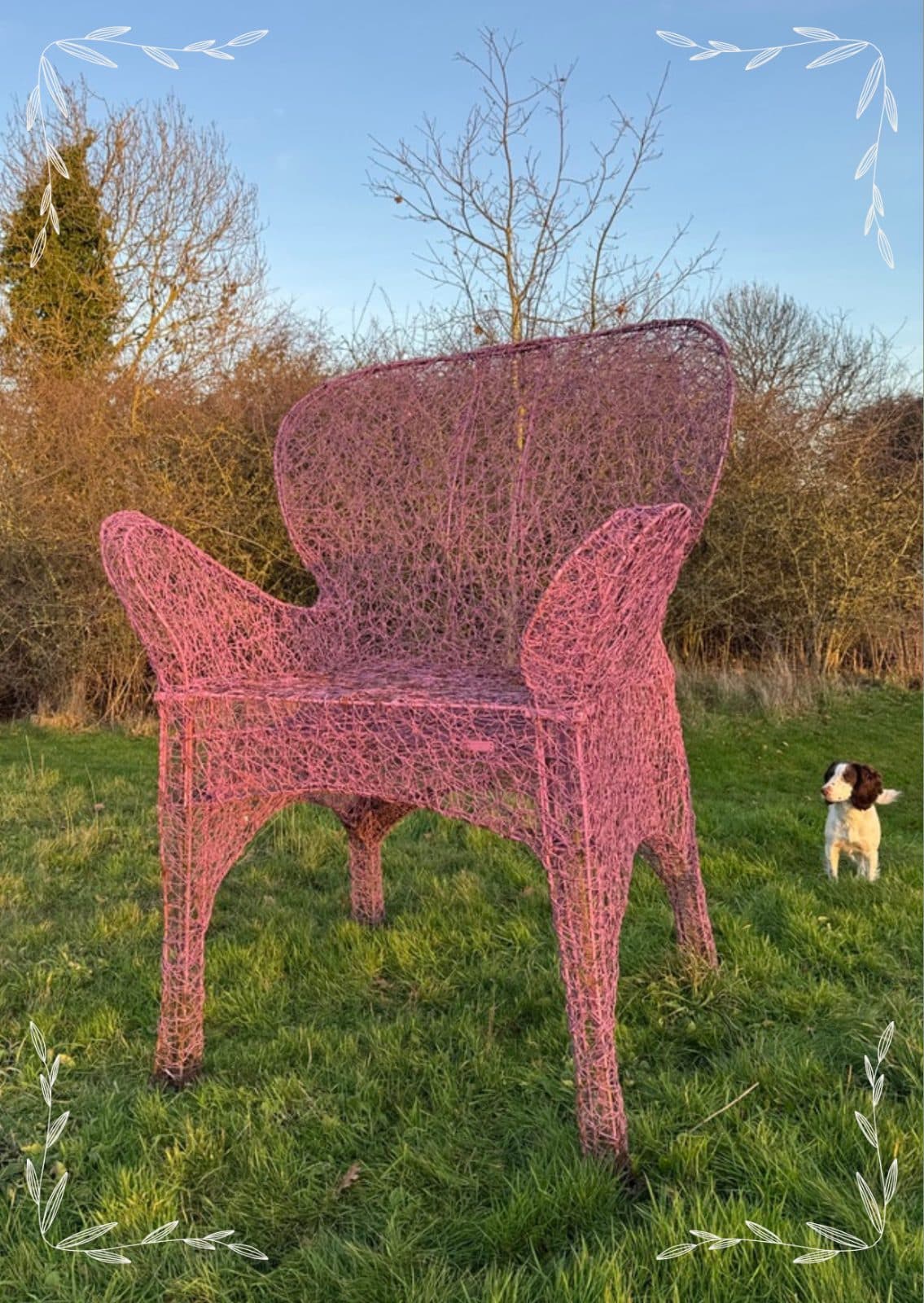 A pink-painted vintage wirework garden chair out in the field