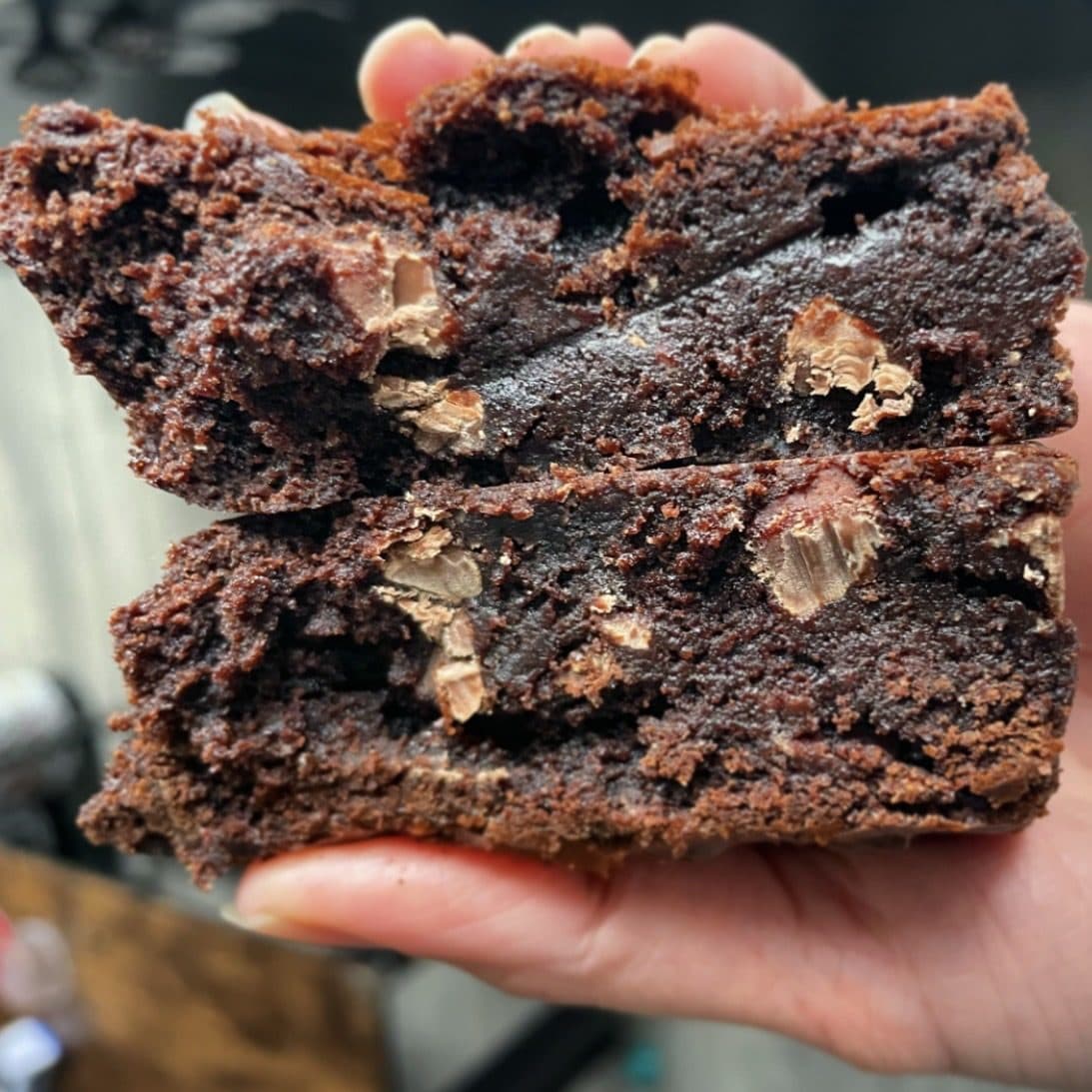 A thick chocolate loaded cookie slice broken open