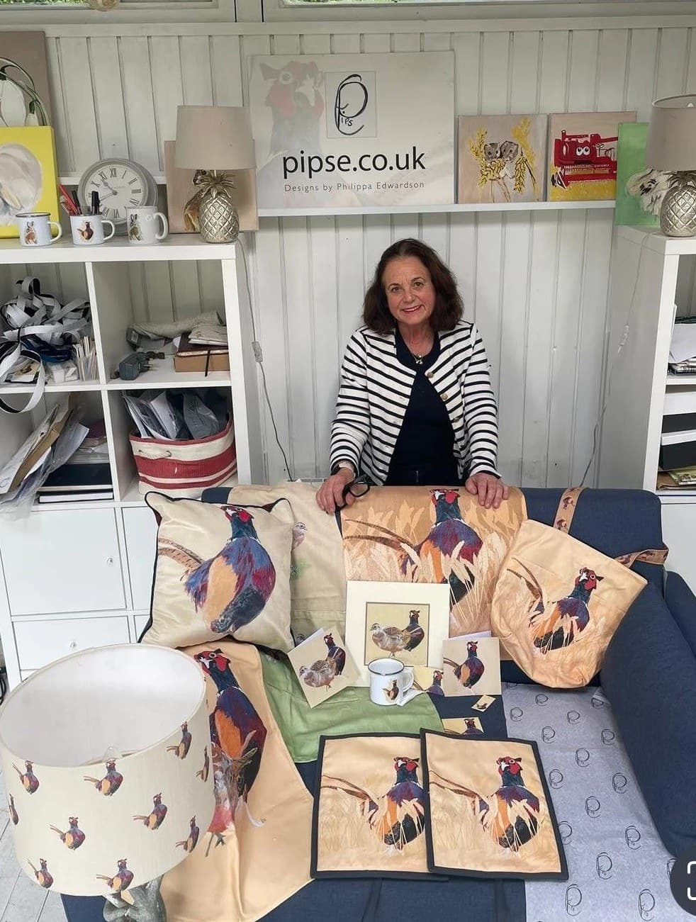 Philippa Edwardson in her studio with her pheasant collection — cushions, a lampshade, bags, placemats and cards